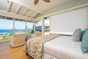 A bedroom with a large bed, a view of the ocean, and a balcony with chairs. - Kapalua Bay | Ocean View 3 BR, Sleeps 10 | Car Incl. w/ 6+ Nights | KBV ML-1963 by KBM (Lahaina)