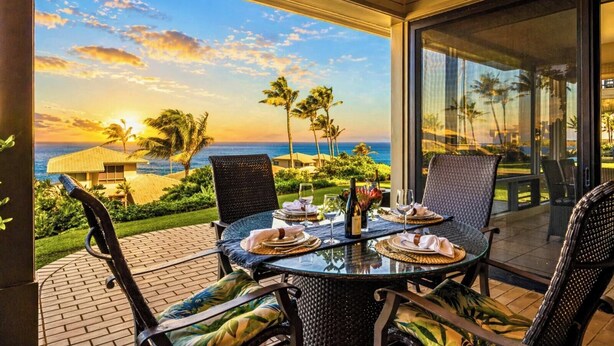 A table set for dining with a view of the ocean and palm trees. - Kapalua Bay | Ocean View 3 BR, Sleeps 10 | Car Incl. w/ 6+ Nights | KBV ML-1963 by KBM (Lahaina)