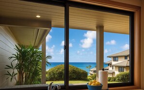 A modern room with a large sliding glass door, a view of the ocean, and a bowl of lemons on the windowsill. - Kapalua Bay | Ocean View 3 BR, Sleeps 10 | Car Incl. w/ 6+ Nights | KBV ML-1975 by KBM (Lahaina)