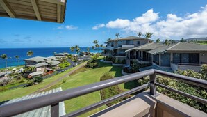 A coastal property with multiple houses, a view of the ocean, and a well-maintained lawn. - Kapalua Bay | Ocean View 3 BR, Sleeps 10 | Car Incl. w/ 6+ Nights | KBV ML-1969 by KBM (Lahaina)