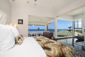 A hotel room with a bed, a desk, and a view of the ocean. - Kapalua Bay | Ocean View 3 BR, Sleeps 8 | Car Incl. w/ 6+ Nights | KBV ML-1993 by KBM (Lahaina)