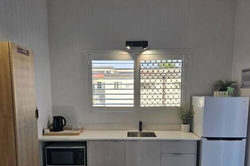 Full-sized fridge, microwave, cookware/dishes/utensils