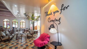 A modern lounge area with a 'Thank you for Coming' sign, comfortable seating, and a decorative plant. - Madeline Paradise Resort (Panglao)
