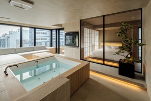 A modern bathroom with a glass-enclosed bathtub, a large window, and a view of the city. - MOKU Kyoto (Kyoto)