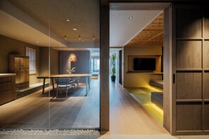 A modern interior with a dining area, kitchen, and seating space. - MOKU Kyoto (Kyoto)