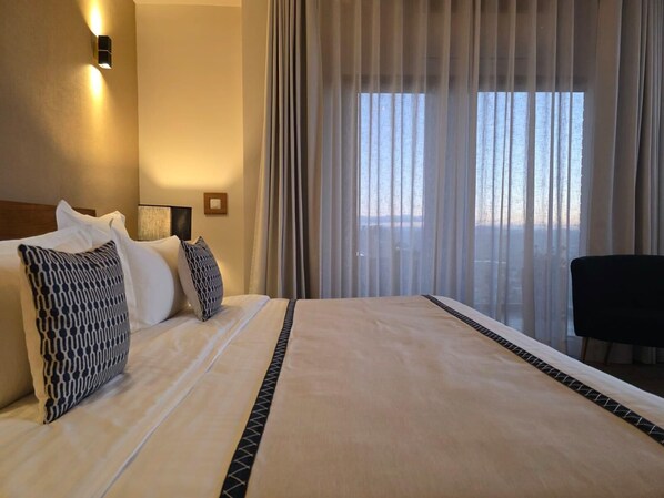 Deluxe Suite, Balcony, City View | Egyptian cotton sheets, premium bedding, pillow-top beds, minibar