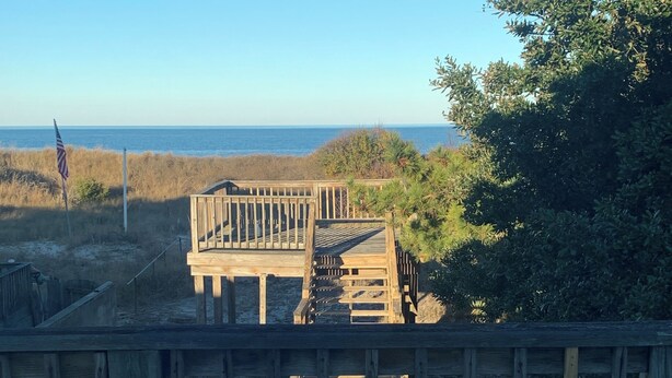 A wooden deck leading to a beach area with a view of the ocean. - Mermaid's and Mutts Retreat - 30 Day Listing (Norfolk)