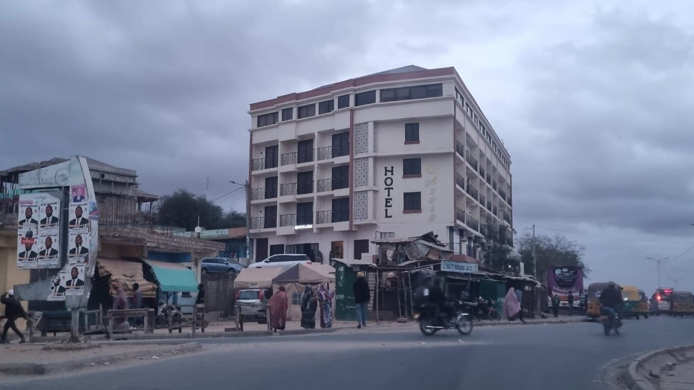 Un hotel de varios pisos con balcones y un cartel que indica que es un hotel.