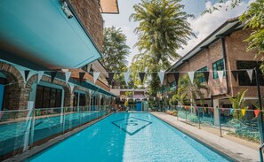 2 outdoor pools, open 7:00 AM to 10:00 PM, pool umbrellas, pool loungers