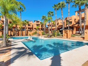 A resort with a swimming pool, palm trees, and multi-story buildings. - Cerro del Sol 6 by Interhome (Torrevieja)