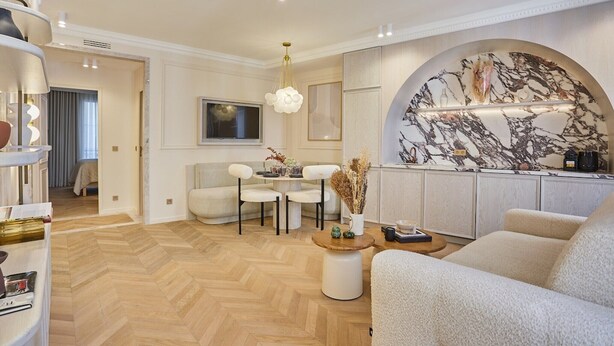 A modern living room with a herringbone floor, a sofa, a coffee table, and a TV. - Apartment in the Marais with Air-conditioned (Paris)