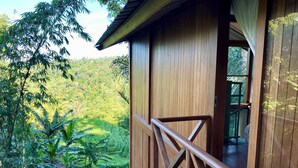 A wooden cabin with a balcony overlooking a lush, green landscape. - Hilltop Retreat Beneath Mt. Batukaru (Selemadeg)