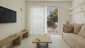 A modern living room with a sofa, a coffee table, a TV, and a bench. - Swan Lake (Ioannina)
