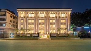 A large, well-lit hotel with multiple balconies and a prominent entrance.