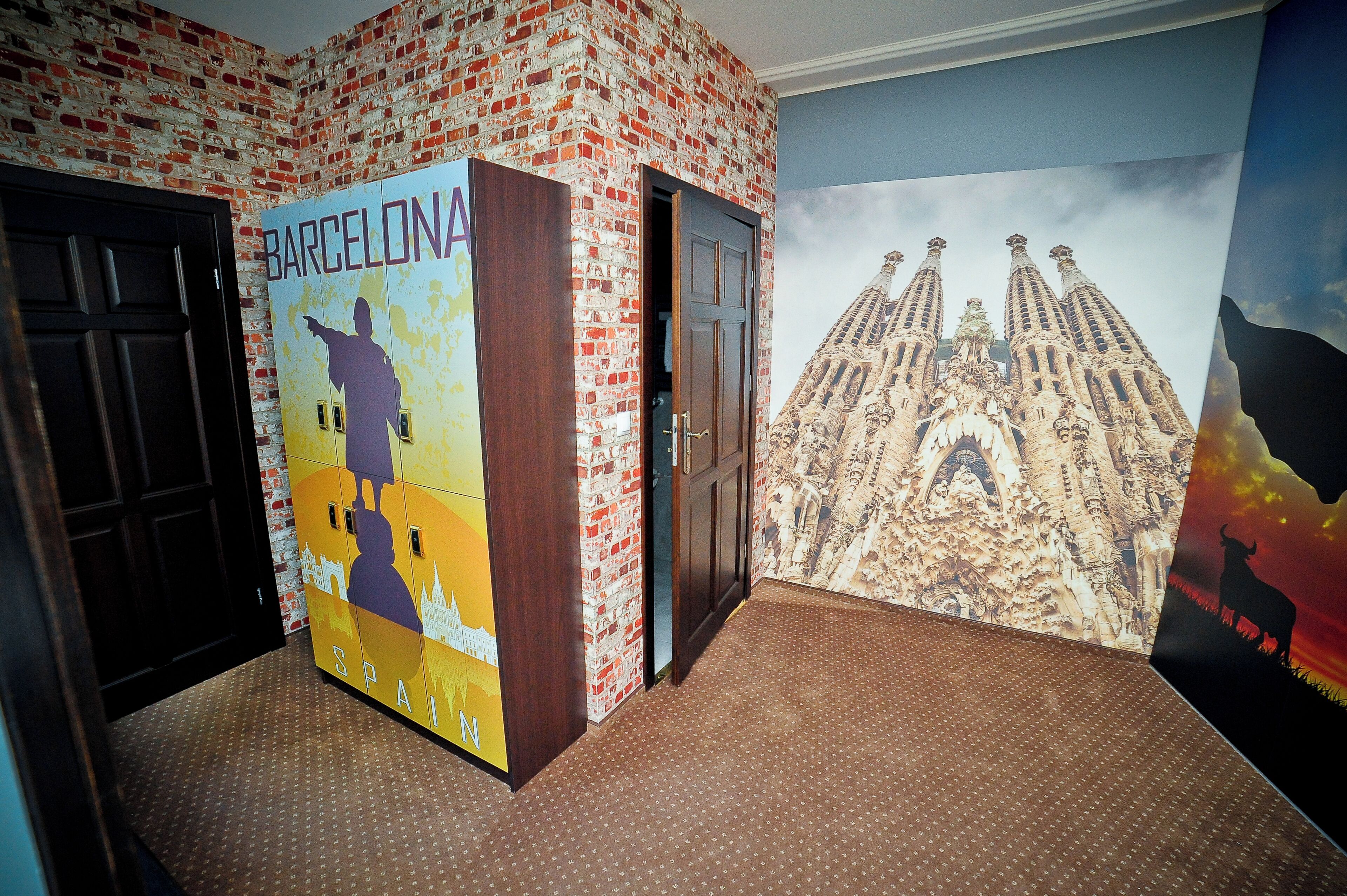 A hallway with a brick wall, a door, and a mural of a famous building.