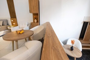 A modern living room with a sofa, a wooden coffee table, and a white chair. - Central Apartment at Ku’damm | Heart of Berlin (1) (Berlin)