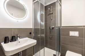 Shower, hair dryer, towels, toilet paper