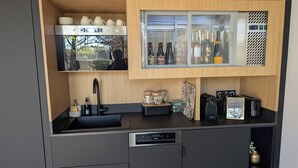 A compact kitchen with a built-in microwave, a sink, and a coffee machine. - Night Experience By Zoo Bordeaux Pessac (Pessac)