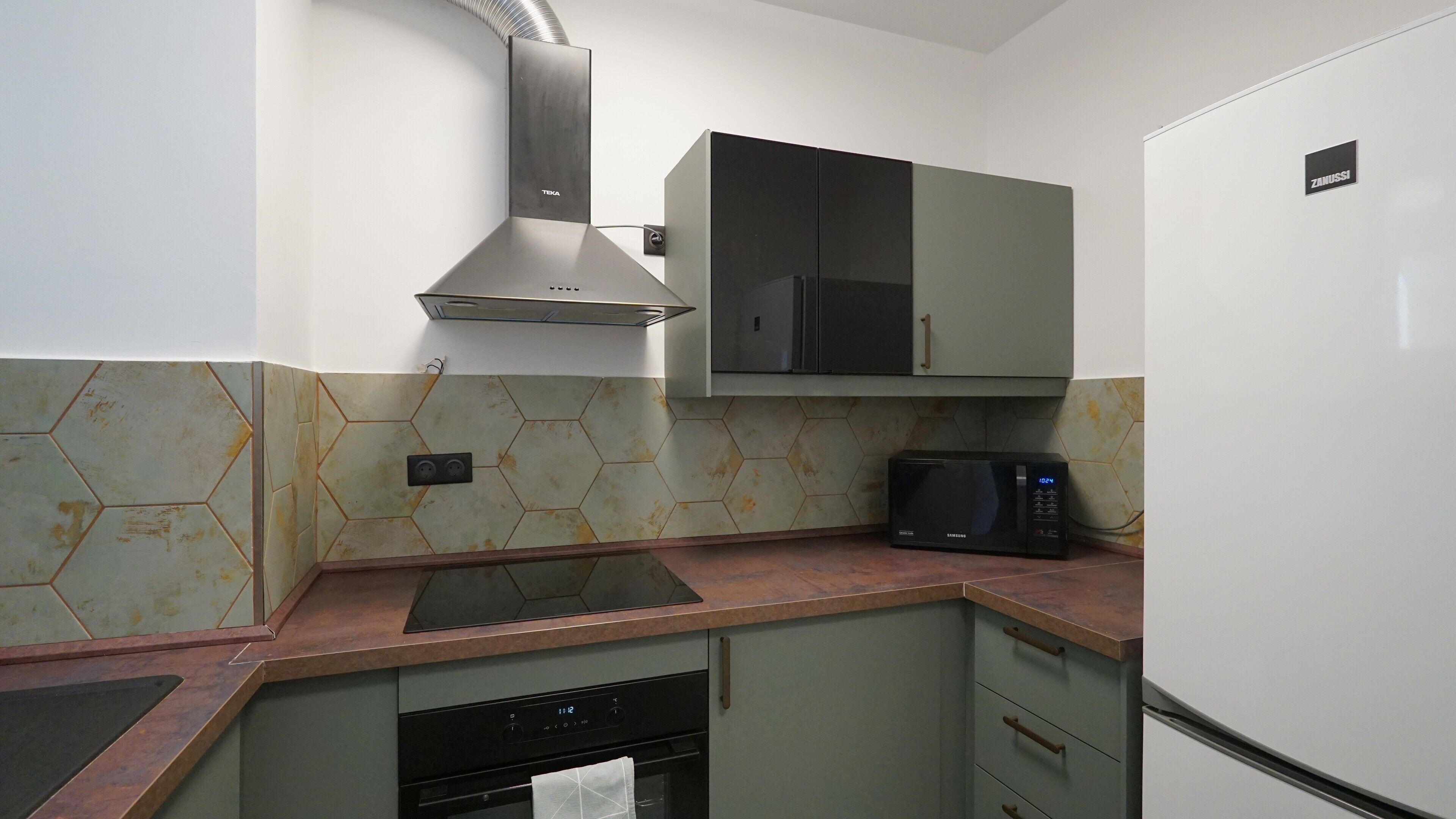 A kitchen with a microwave, stove, and dishwasher.