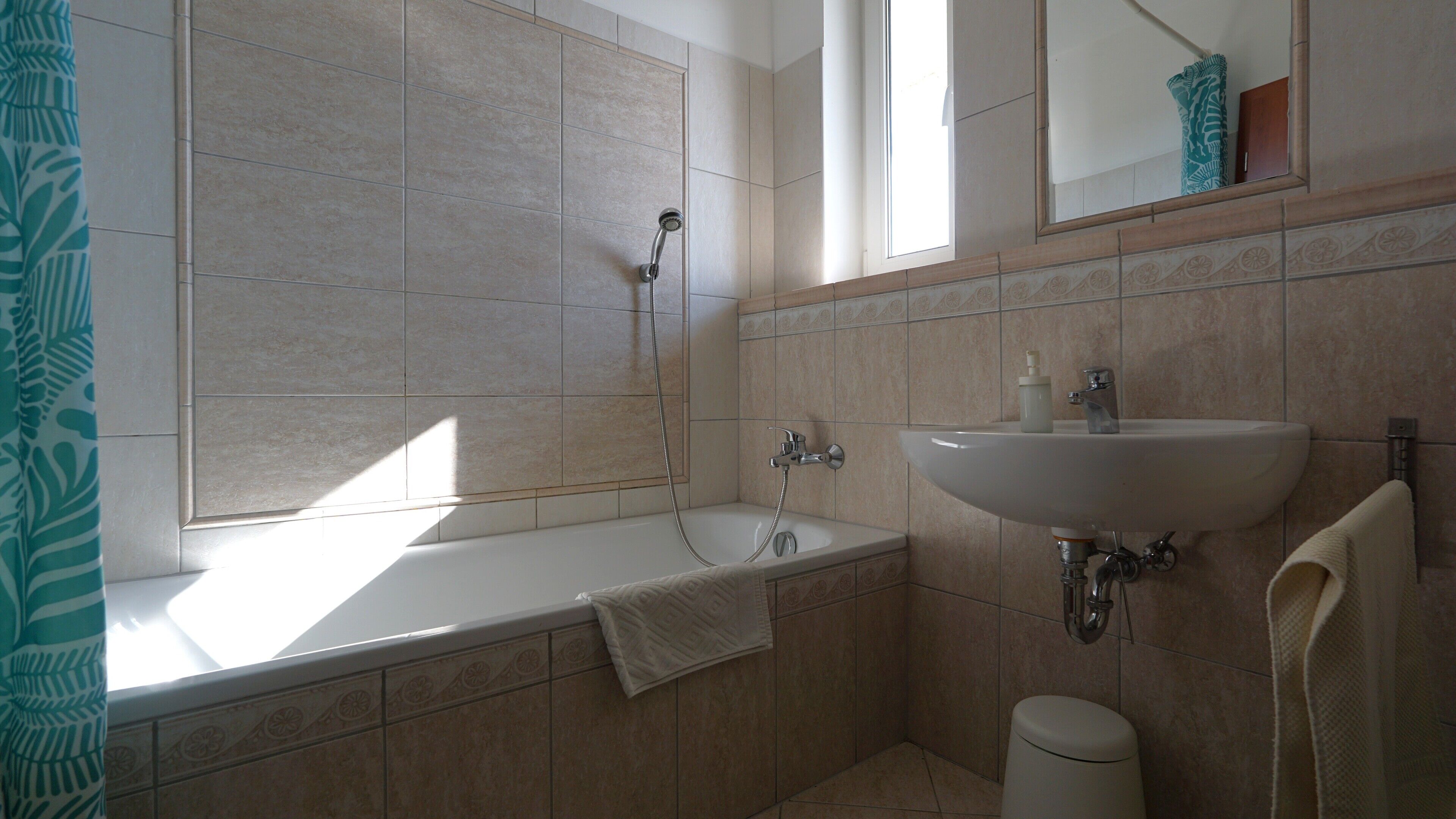 A bathroom with a bathtub, a sink, and a toilet.