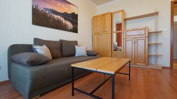 Gold Penthouse Apartment | Living area | 82-cm LED TV with cable channels