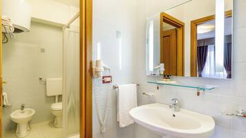 Shower, hair dryer, towels, toilet paper