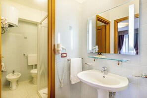 Shower, hair dryer, towels, toilet paper