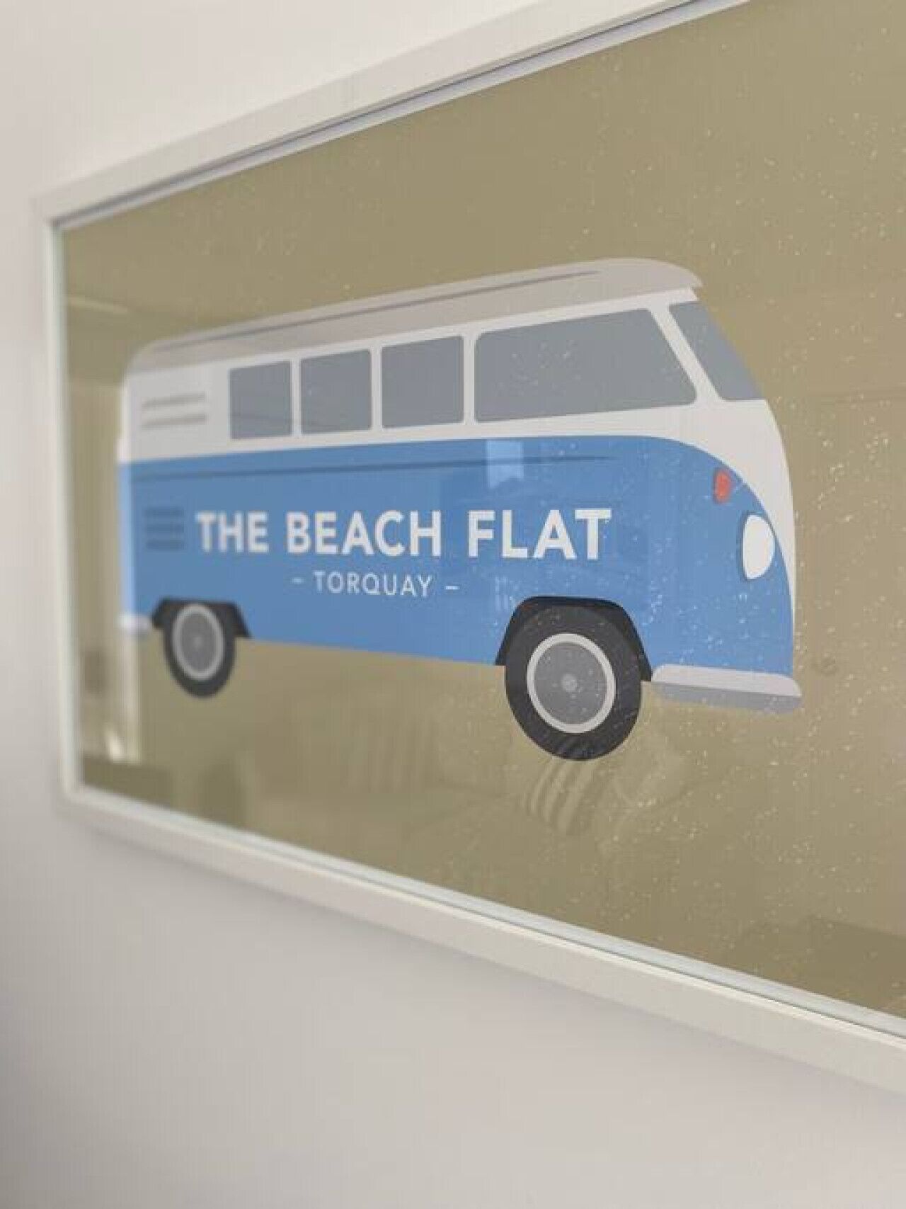 A van with "The Beach Flat - Torquay" written on it.