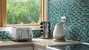 Fridge, coffee/tea maker, cookware/dishes/utensils