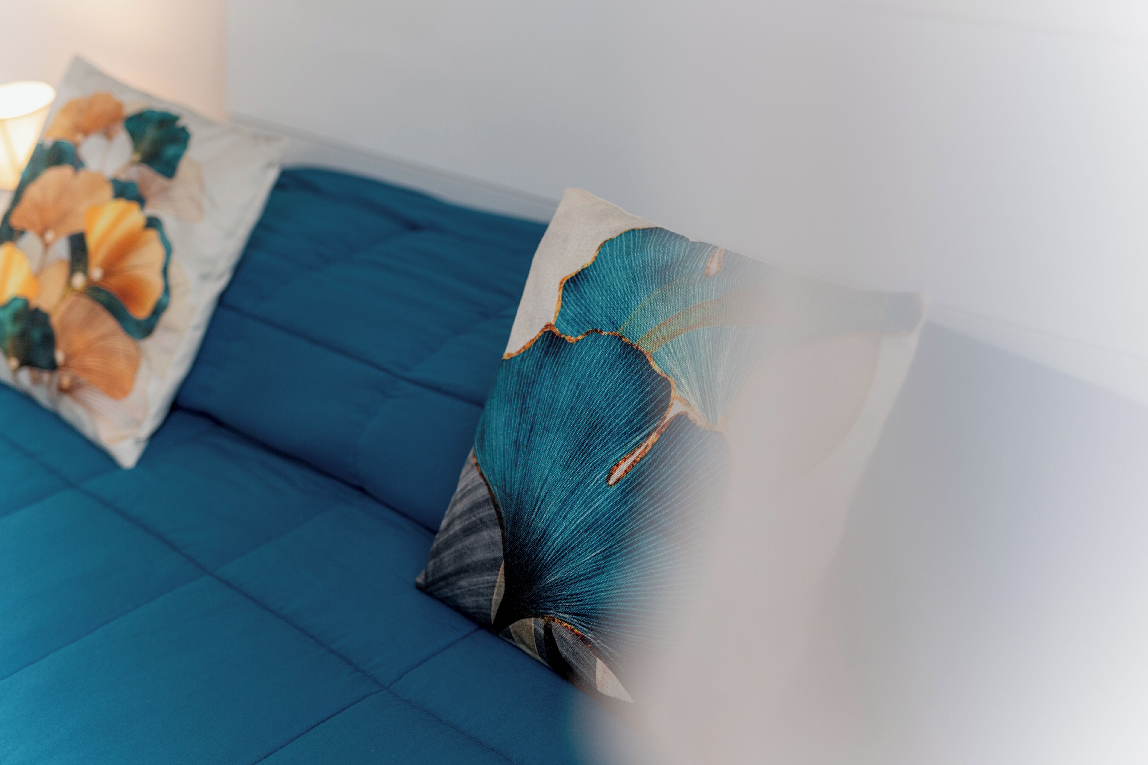 A blue sofa with decorative pillows.