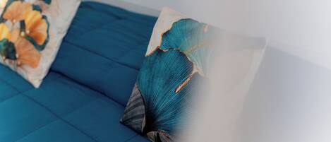 A blue sofa with decorative pillows.