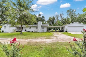 A two-story house with a covered patio and a garage.