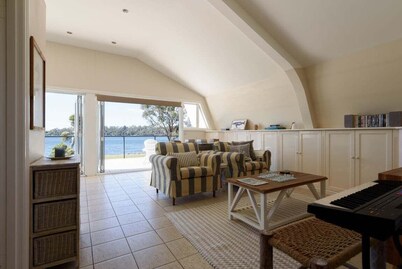 Sunset Sanctuary: Waterfront Home with Balcony and Patio