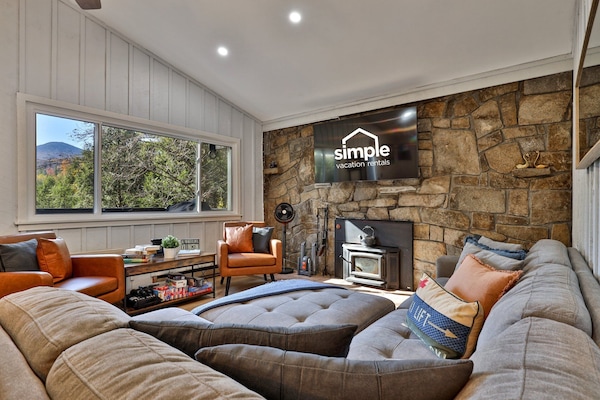 Comfy seating, a wood-burning stove, smart TV and stunning mountain views, perfect for unwinding after a day of adventure.