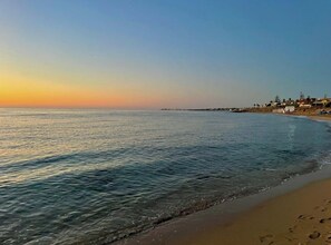 A beach with calm waters and a clear sky. - Beachfront apartment with panoramic view (San Lorenzo)