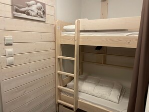 A bunk bed with a ladder, a wooden wall with horizontal panels, and a picture of a bear. - Studio for 4 in Gourette, southwest balcony, pets allowed (Gourette)