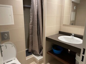 A bathroom with a toilet, a sink, a shower curtain, and a mirror. - Studio for 4 in Gourette, southwest balcony, pets allowed (Gourette)