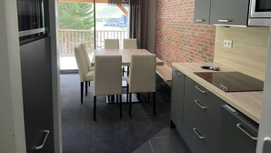 A modern kitchen with grey cabinets, a wooden countertop, and a built-in microwave. - Gourette: 3-room Apt, 8 pers, pool (Gourette)