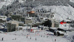 A ski resort with multiple buildings, including a large hotel with a ski lift visible. - Comfortable studio, 6 pers, mountain view, pets allowed, sheets provided (Gourette)