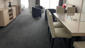 A hotel room with a bed, a desk, a chair, a sofa, and a TV. - Gourette: 66m² apt for 8, pool, pets allowed (Gourette)