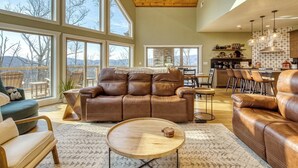 A spacious living area with large windows, a wooden ceiling, and a cozy seating arrangement. - Ritzy Bear Lodge, Game Room, Mountain Views, WIFI, Fireplace on deck!!! (Sevierville)