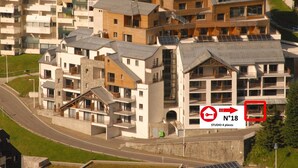 A modern residential building with multiple balconies and a mix of architectural styles.