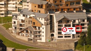 A modern apartment complex with multiple buildings, balconies, and solar panels. - Gourette studio pool 4 pers., pets allowed (Gourette)
