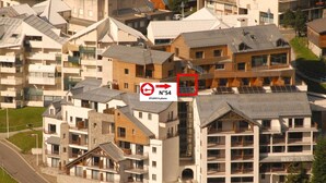 Un edificio residenziale a più piani con un mix di stili architettonici moderni e tradizionali, caratterizzato da balconi e un cortile centrale.