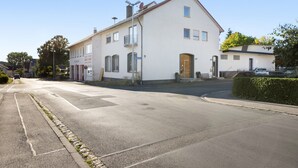 A two-story residential building with a flat roof, a front door, and a visible satellite dish. - Apartment '2' with Wi-Fi (Bad Kissingen)