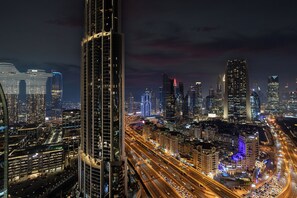 A nighttime cityscape with high-rise buildings, busy highways, and illuminated streets. - Abi Holidays Dubai Mall Fashion Avenue  (Dubai)