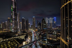 A nighttime cityscape with illuminated skyscrapers and a complex network of roads. - Abi Holidays Dubai Mall Fashion Avenue  (Dubai)