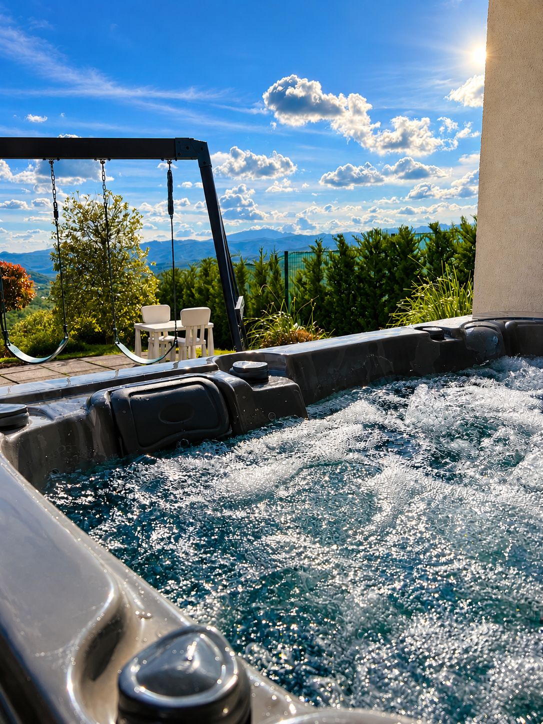 A hot tub with a view of mountains and greenery.