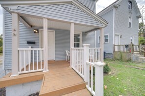 A house with a wooden deck, white railings, and a covered porch. - Modern & Convenient! Group Stay in Highland Square (Akron)
