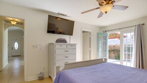 A bedroom with a bed, a television, a ceiling fan, a dresser, and a window with curtains. - Family Home, 7 Mi to Joshua Tree National Park! (Twentynine Palms)
